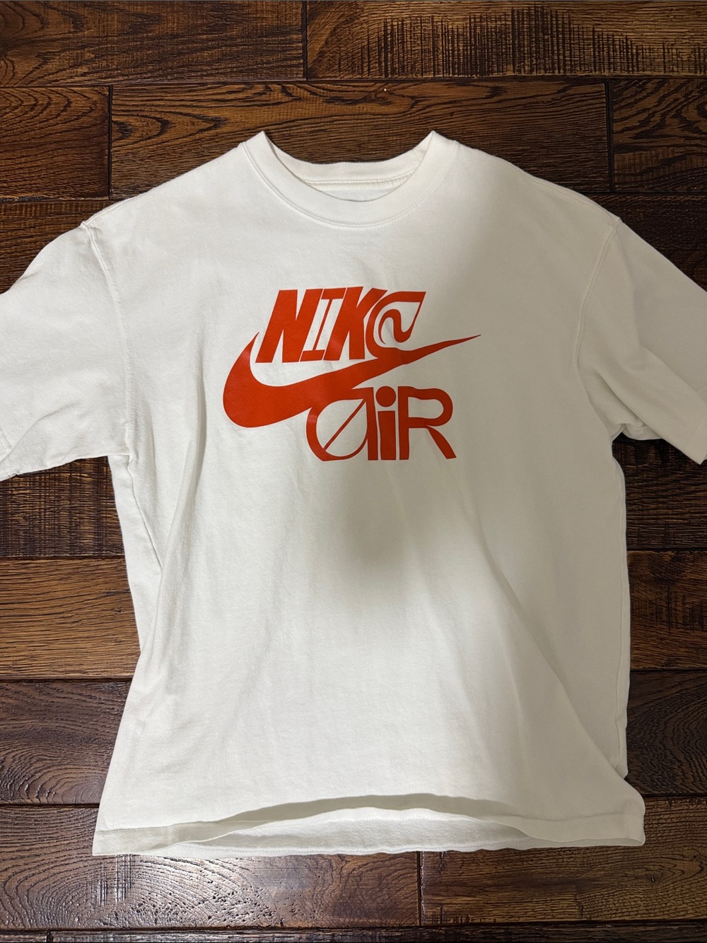 Nike White Short Sleeve Tee with Orange Swoosh Graphic